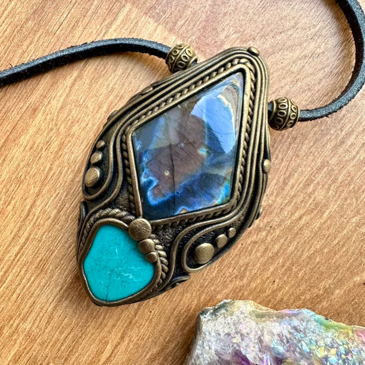 Necklace with a decorative pendant featuring a blue stone on a wooden surface