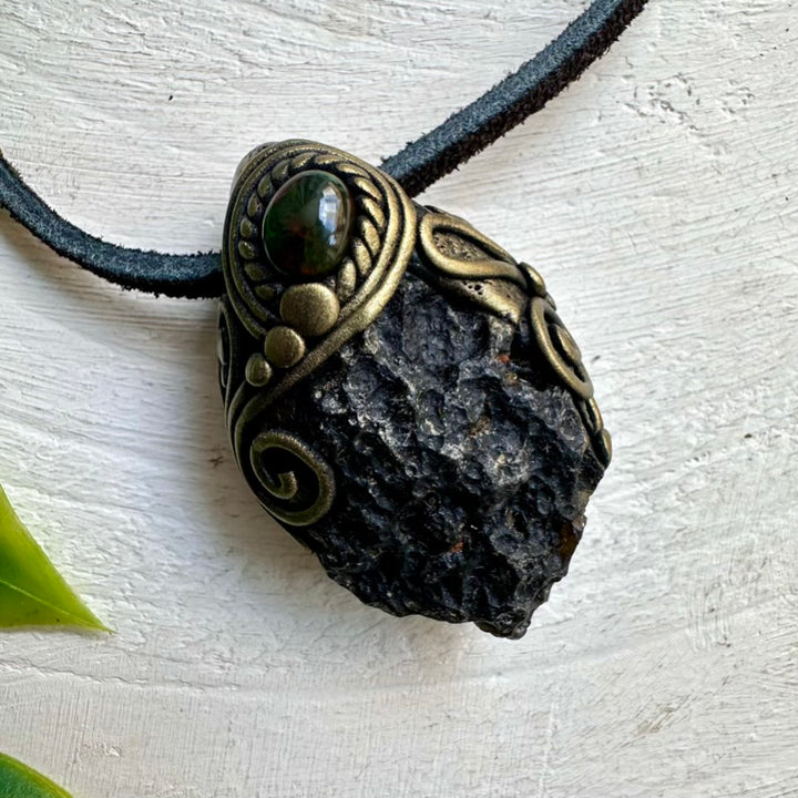This raw crystal necklace combines the grounding, protective energy of Black Tektite with the mystical iridescence of Ethiopian Opal.