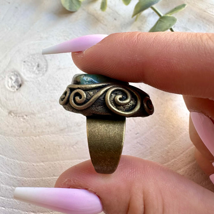 Artisan ring featuring natural Emerald and Raw Ethiopian Opal in a unique handmade setting.