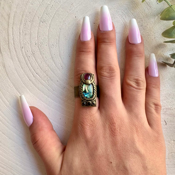One of a kind Abalone Seashell ring handcrafted with natural Garnet and Sapphire gemstones.