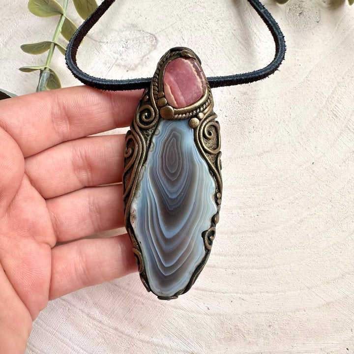 Fantasy inspired crystal necklace featuring rhodochrosite and Botswana agate healing gemstones