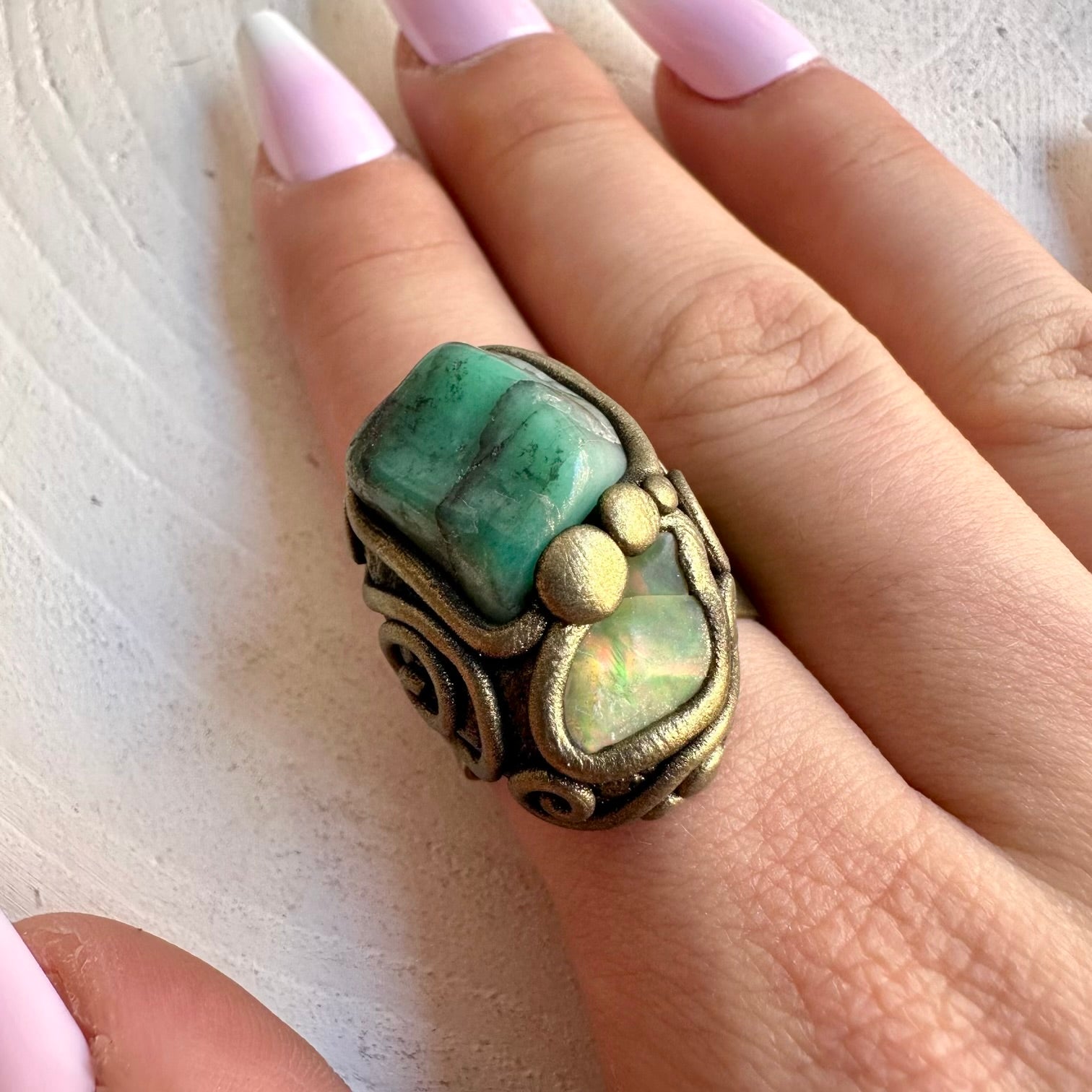 Handmade healing crystal ring featuring Emerald and Raw Ethiopian Opal.
