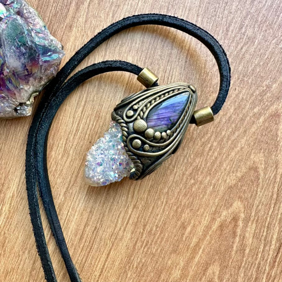 Angel Aura Quartz Necklace with decorative pendant on a wooden surface