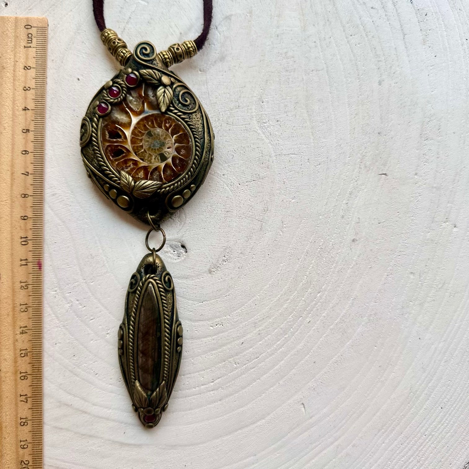 Handmade statement crystal necklace featuring a natural Ammonite with Labradorite and Rhodolite Garnet