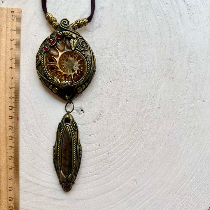 Handmade statement crystal necklace featuring a natural Ammonite with Labradorite and Rhodolite Garnet