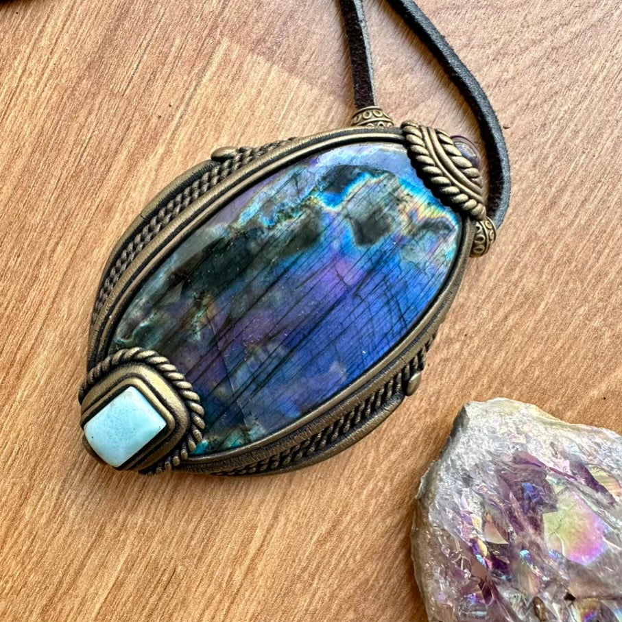 Handmade crystal pendant on a wooden surface
