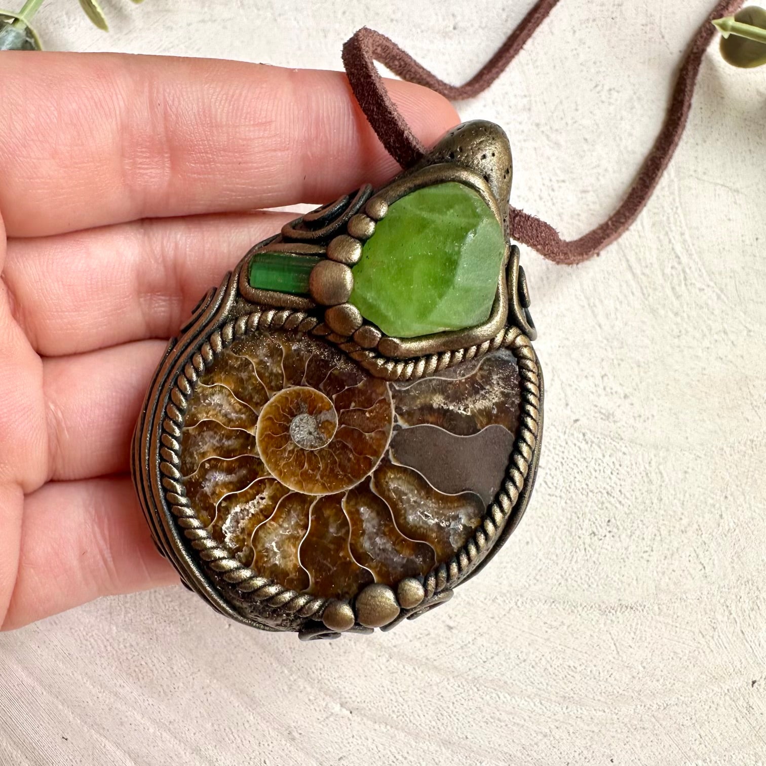 Earthy spiritual crystal jewelry necklace with ammonite fossil and green tourmaline details