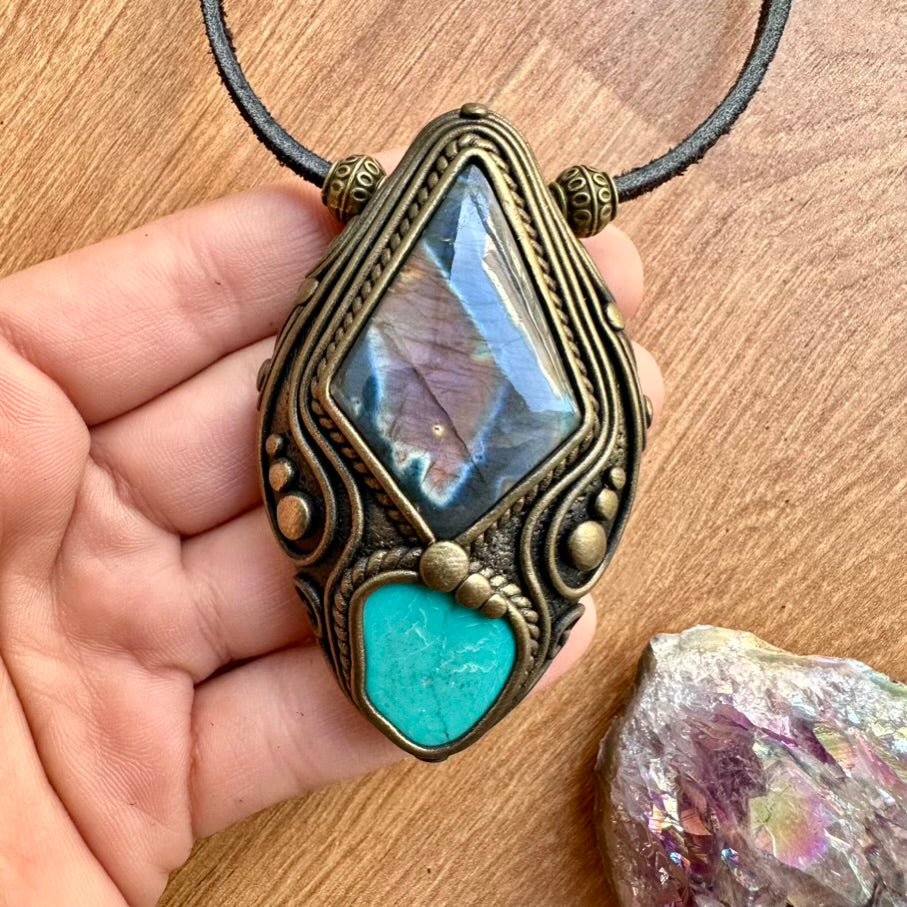 Healing Crystal Necklace held in a hand on a wooden surface