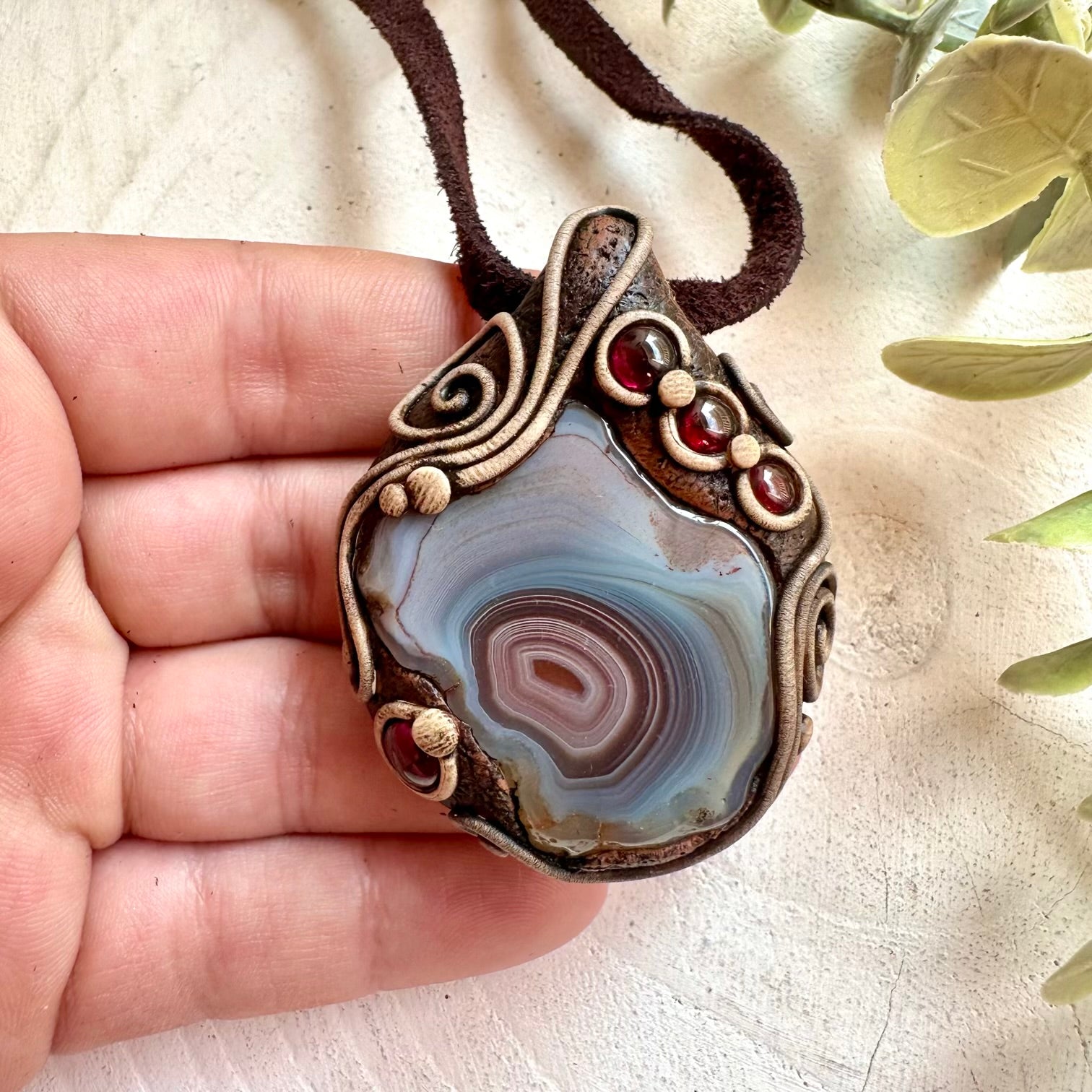 Handmade healing crystal necklace featuring Botswana Agate and Rhodolite Garnet natural stones.