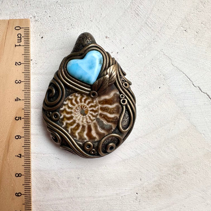 Healing gemstone necklace featuring larimar heart crystal and ammonite fossil details