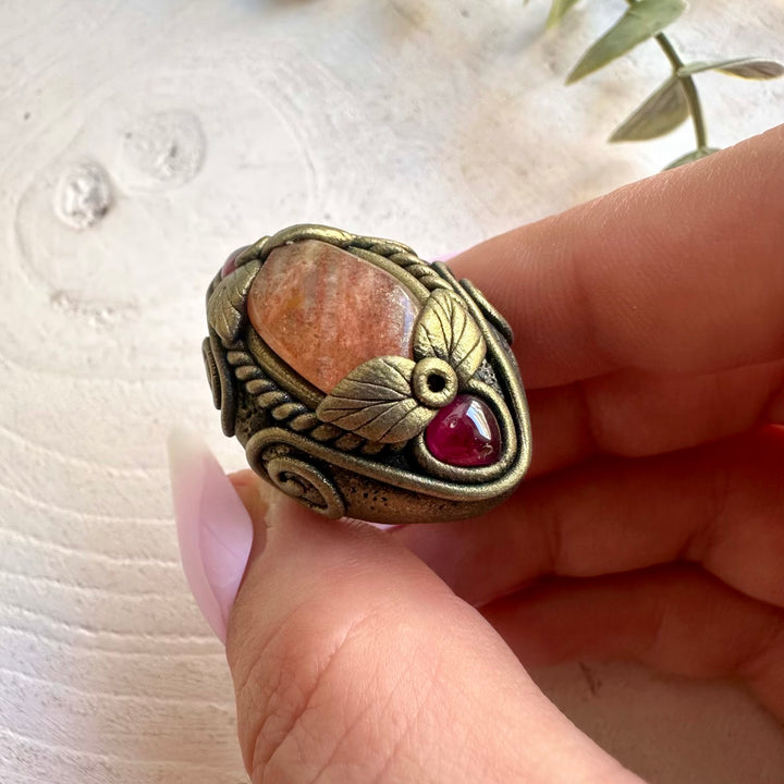 Unique Sunstone jewelry featuring warm golden tones and deep red Garnet.
