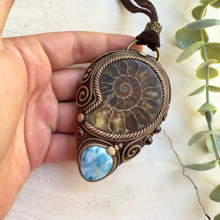 Close up of ammonite fossil and Larimar necklace