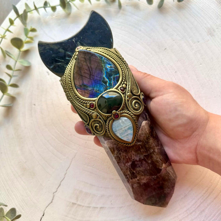 Handmade Super Seven Quartz crystal wand featuring an Astrophyllite Moon, Purple Labradorite, Rainbow Obsidian, Rainbow Moonstone, Amethyst and Rhodolite Garne designed for manifestation, intuition, protection, emotional healing and spiritual awakening.