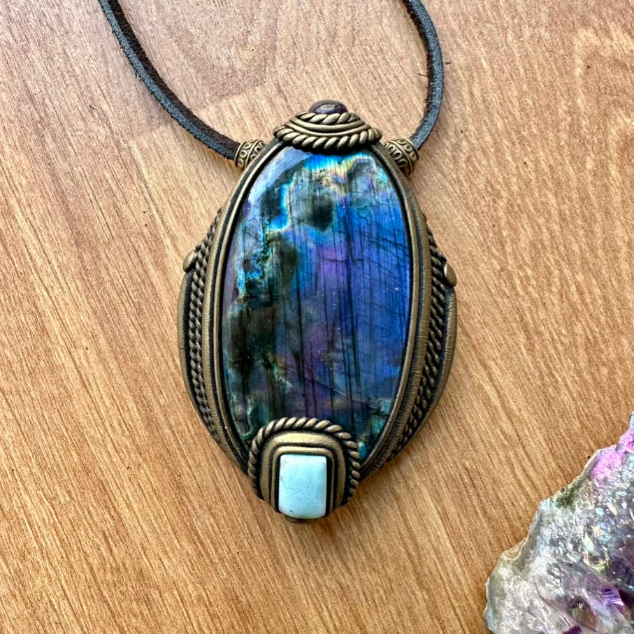 Necklace with a Labradorite pendant on a wooden surface