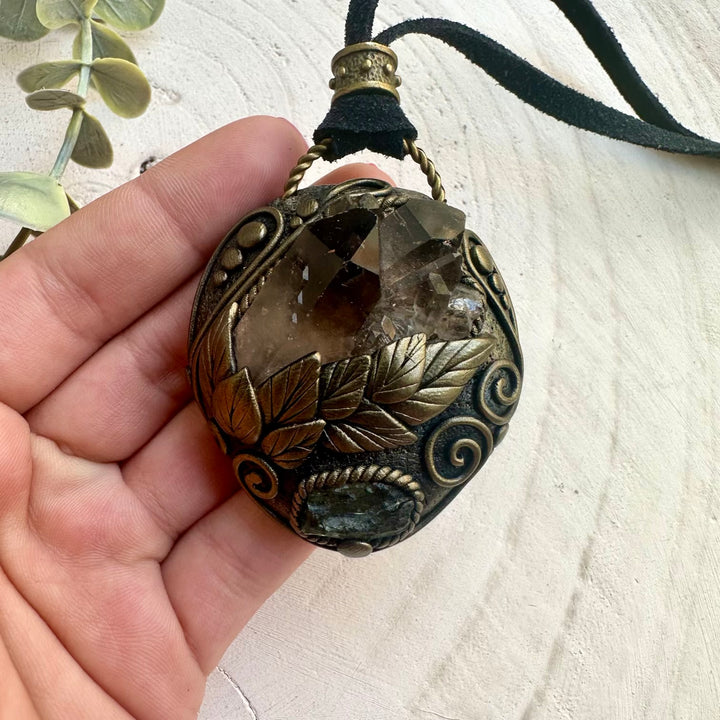 Metaphysical jewelry featuring grounding and transformation crystals moldavite and smoky quartz