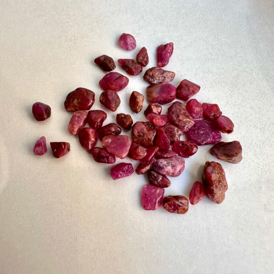 Collection of Ruby healing crystals on a light gray background