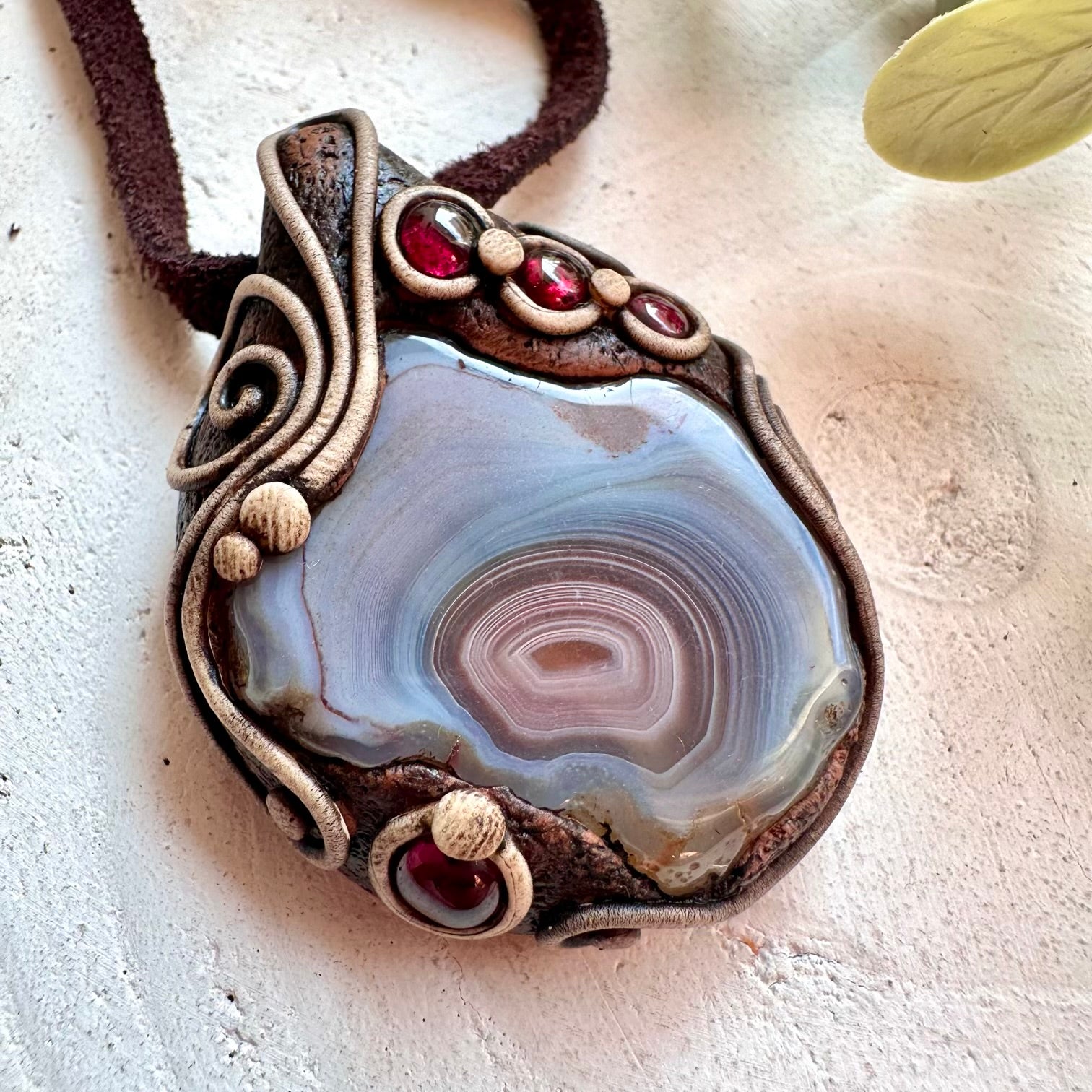 Handmade crystal necklace designed with Botswana Agate for calm energy and Garnet for strength.