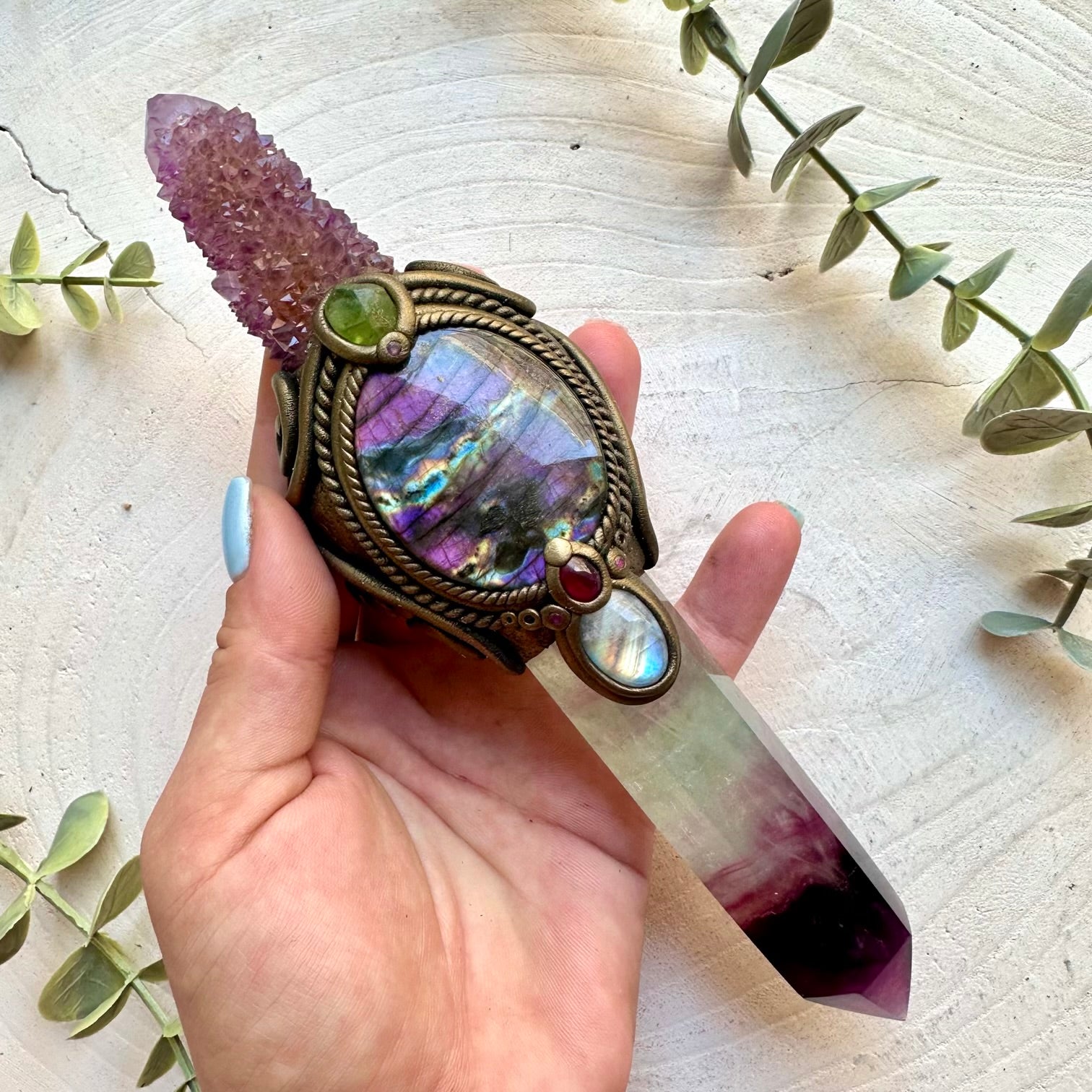 Raw healing crystal wand with Rainbow Fluorite, Deep Purple Spirit Quartz, Purple Labradorite, Rainbow Moonstone, Raw Peridot, Rhodolite Garnet and Ruby.