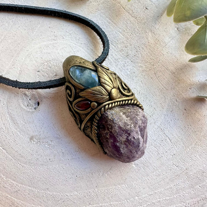 Handmade crystal jewelry showcasing Raw Scapolite with soft blue and deep red gemstone details.