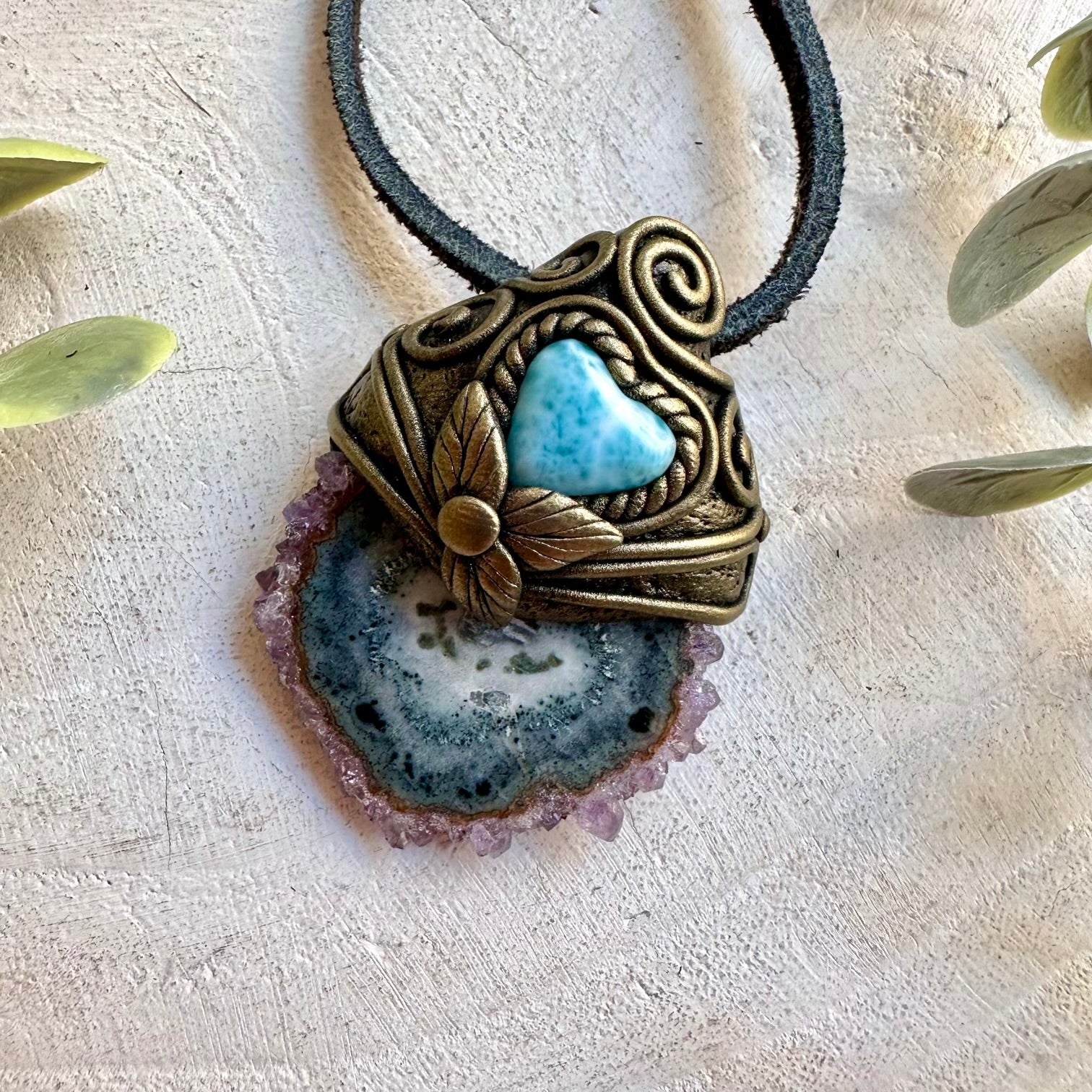 Handmade crystal jewelry with Amethyst Stalactite and Larimar Heart in a unique clay setting.