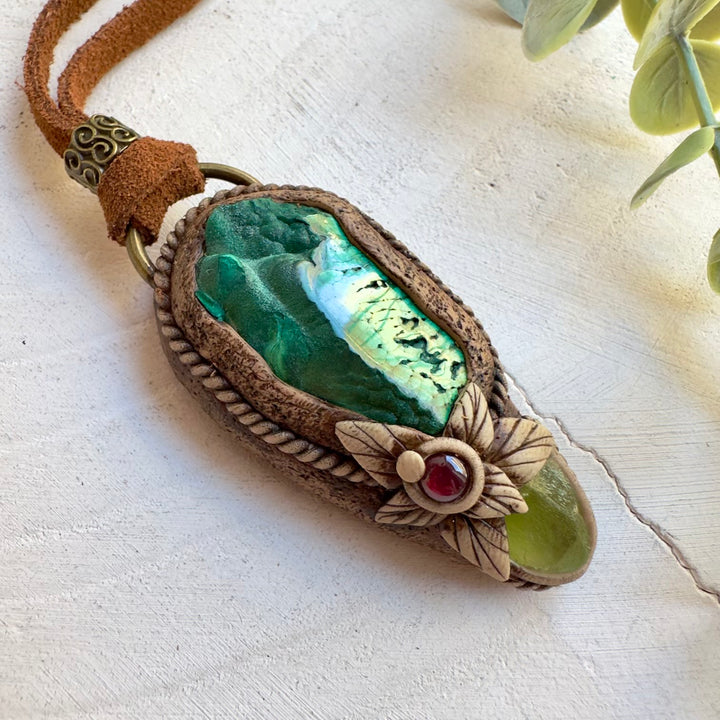 Close up of half polished malachite pendant necklace