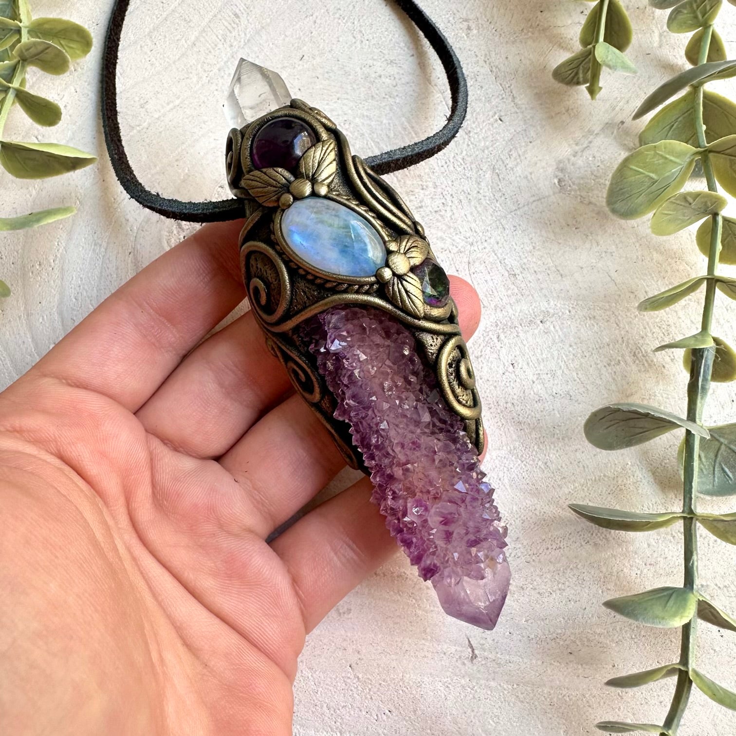 Unique crystal wand pendant featuring a long Spirit Quartz point with shimmering natural gemstones.