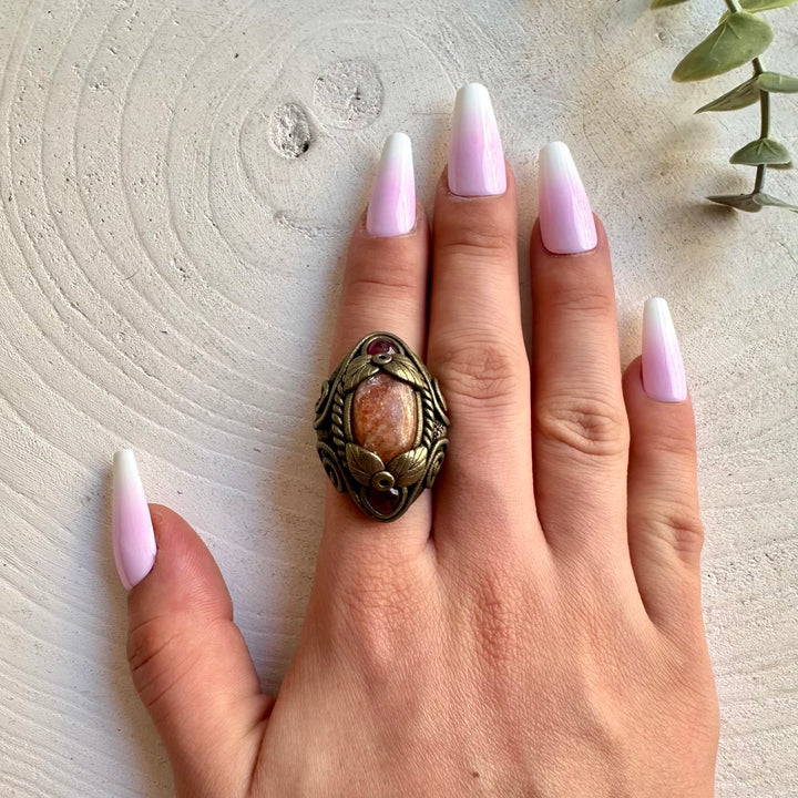 Handmade gemstone ring combining warm Sunstone with rich red Rhodolite Garnet.