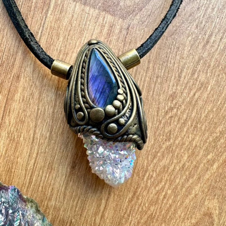 Spiritual Necklace with angel aura spirit quartz and labradorite pendant featuring a blue stone and druzy crystal on a wooden surface.