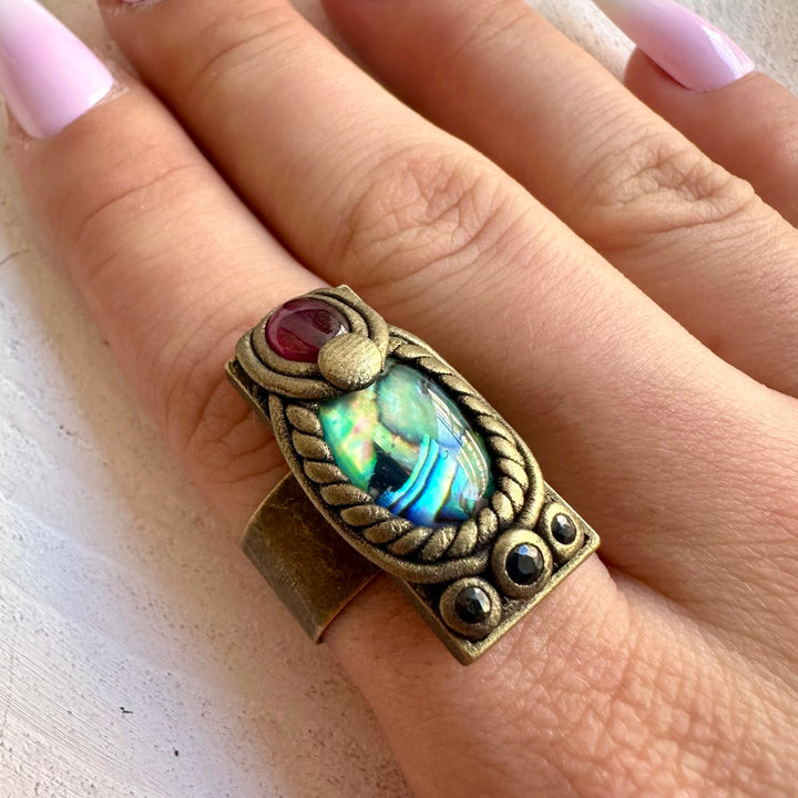 Handmade ring featuring Abalone Seashell, Rhodolite Garnet and Blue Sapphire.