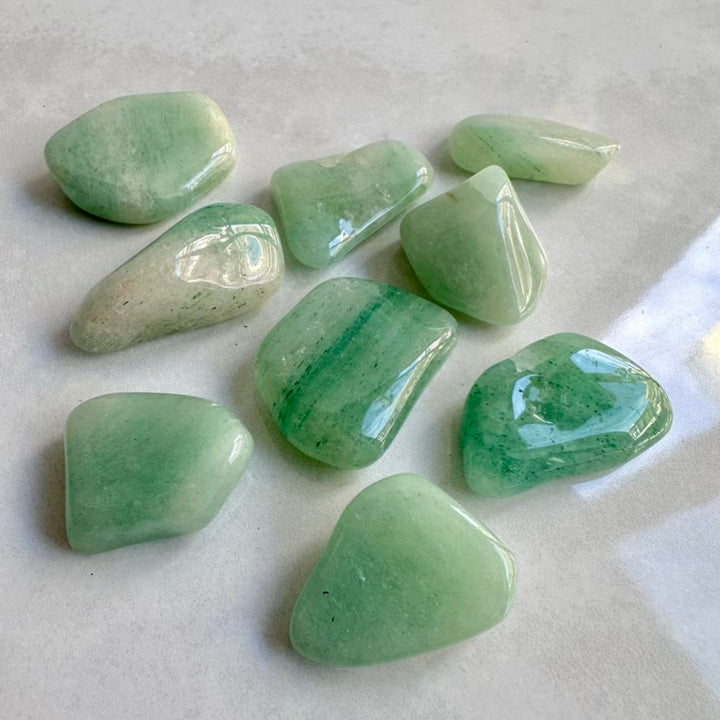 Green Aventurine stones on a light gray background