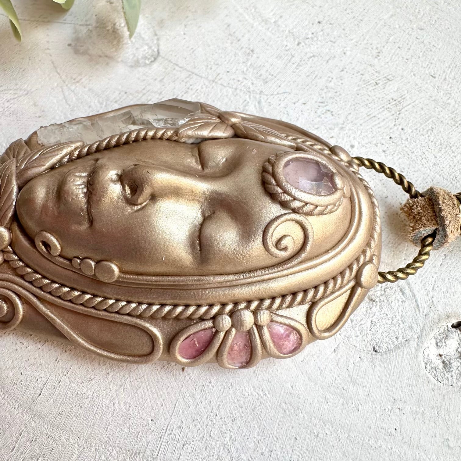 Close up of rose quartz and pink tourmaline goddess pendant