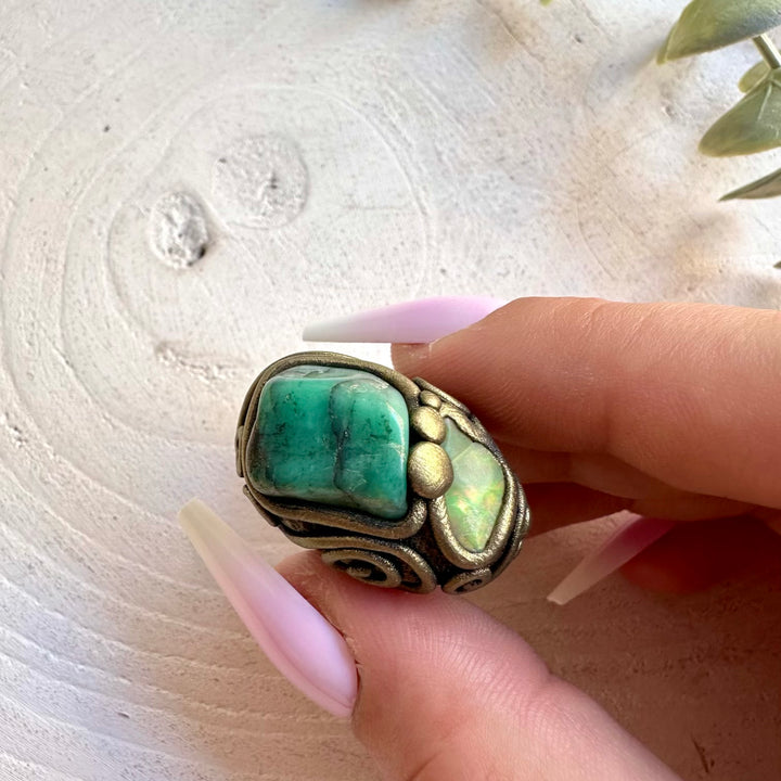Handmade gemstone ring combining rich green Emerald with an iridescent Ethiopian Opal.