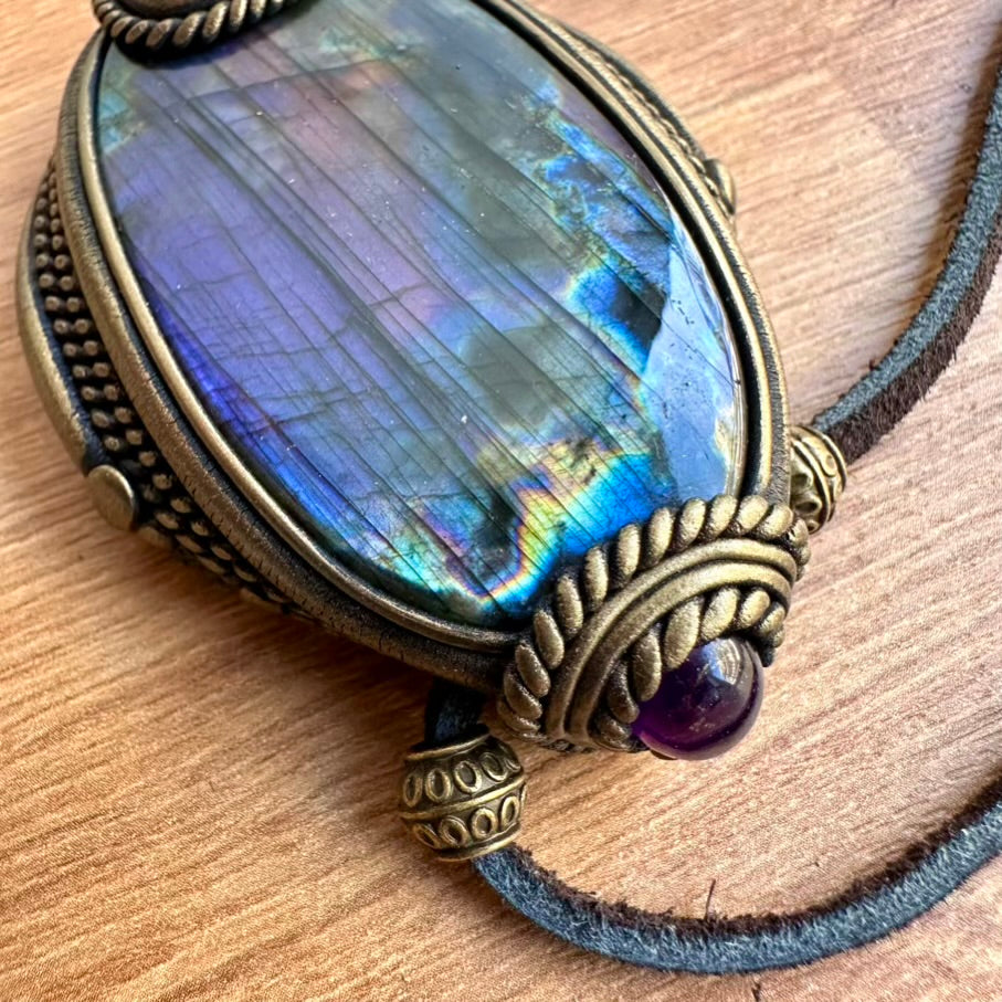 Necklace with a Labradorite stone pendant on a wooden surface