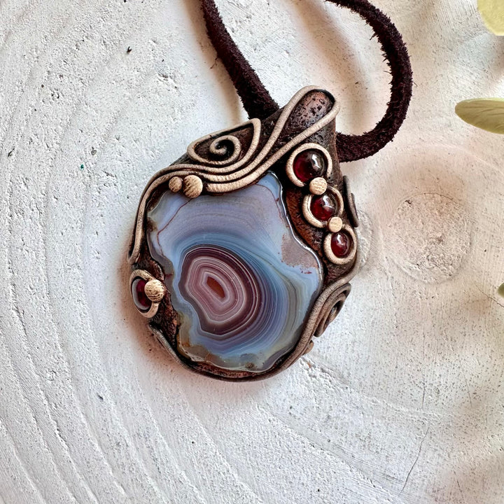 Metaphysical crystal jewelry featuring Botswana Agate and Garnet for transformation and healing.