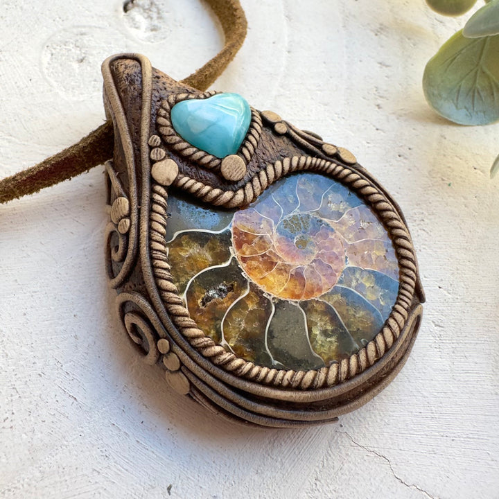 Close up of ammonite fossil and Larimar heart pendant necklace
