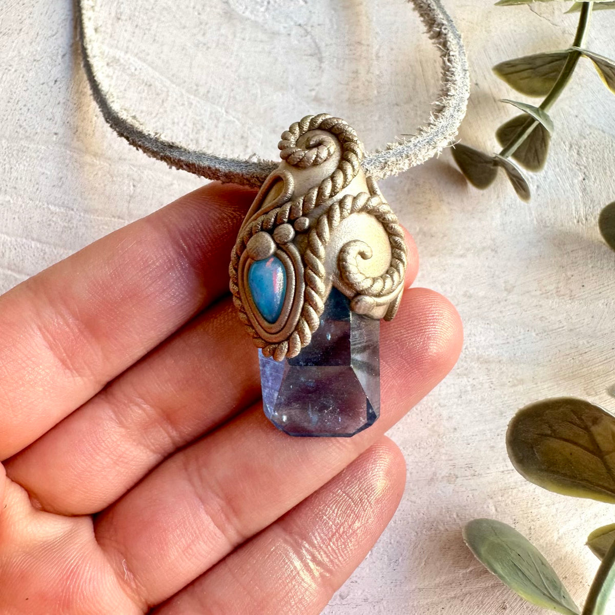 Handmade Aqua Aura Quartz and Blue Ethiopian Opal pendant necklace, a one of a kind healing crystal jewelry piece combining the luminous iridescent beauty of Aqua Aura Quartz with the captivating blue flashes of Ethiopian Opal.