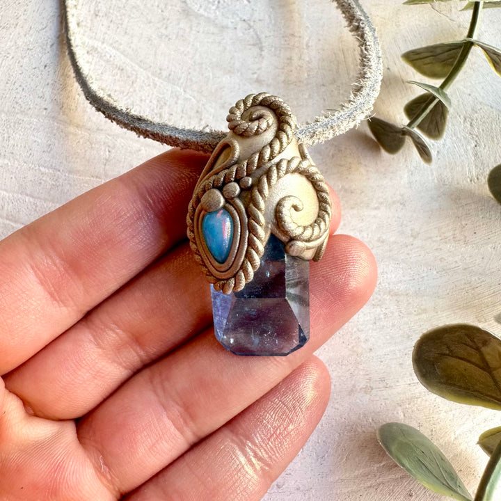 Handmade Aqua Aura Quartz and Blue Ethiopian Opal pendant necklace, a one of a kind healing crystal jewelry piece combining the luminous iridescent beauty of Aqua Aura Quartz with the captivating blue flashes of Ethiopian Opal.