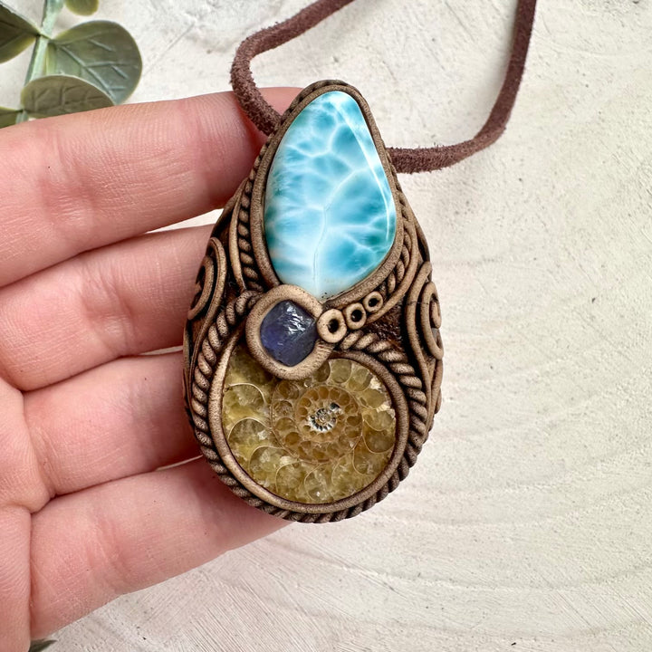 Healing crystal pendant with ammonite fossil and larimar