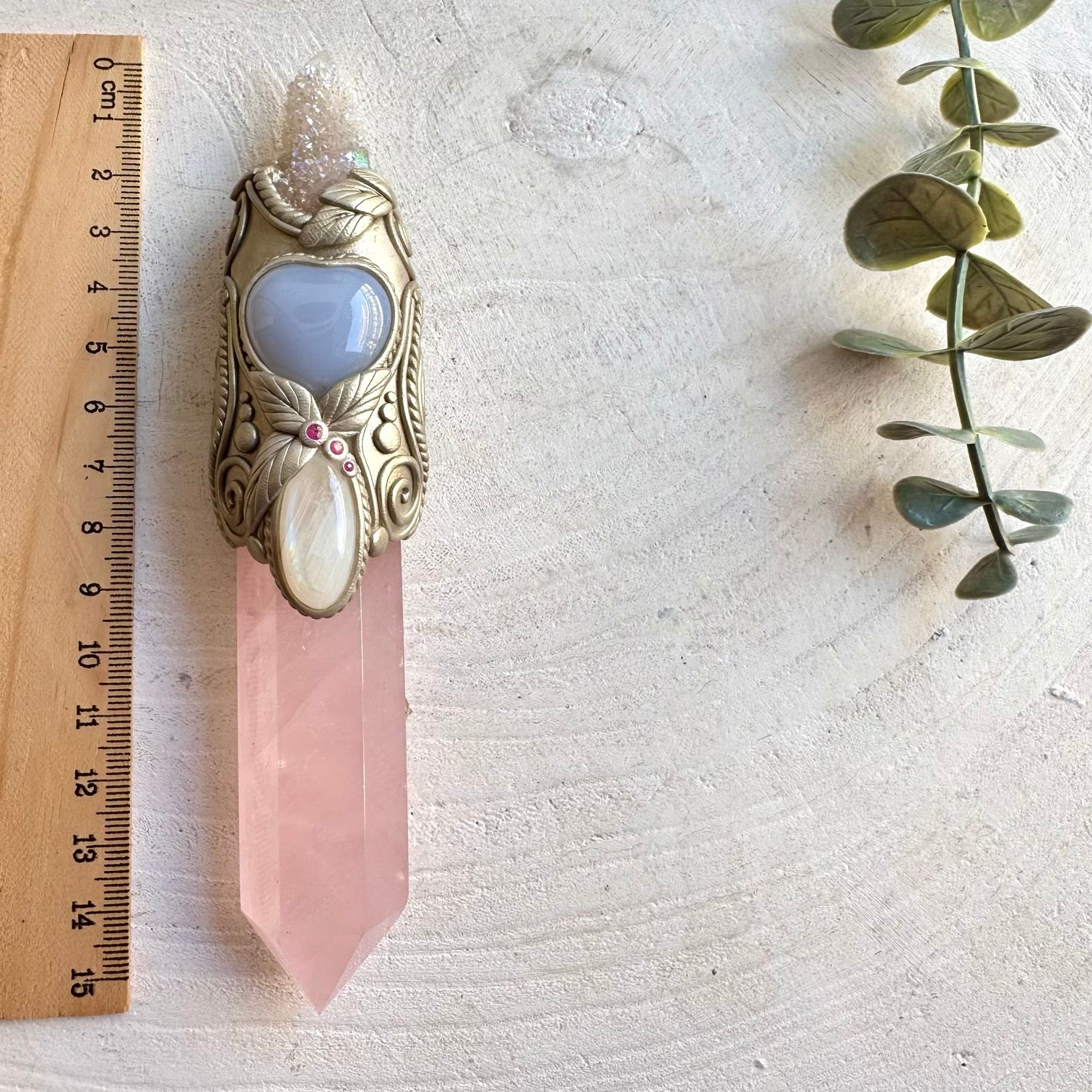 Handmade Rose Quartz healing crystal wand and pendant necklace featuring Angel Aura Spirit Quartz, Moonstone, Blue Chalcedony Heart and Ruby. A one of a kind spiritual energy tool combining soft pink, luminous, blue and vibrant red gemstones, created for meditation, intention setting, energy work, self-love and spiritual practice.