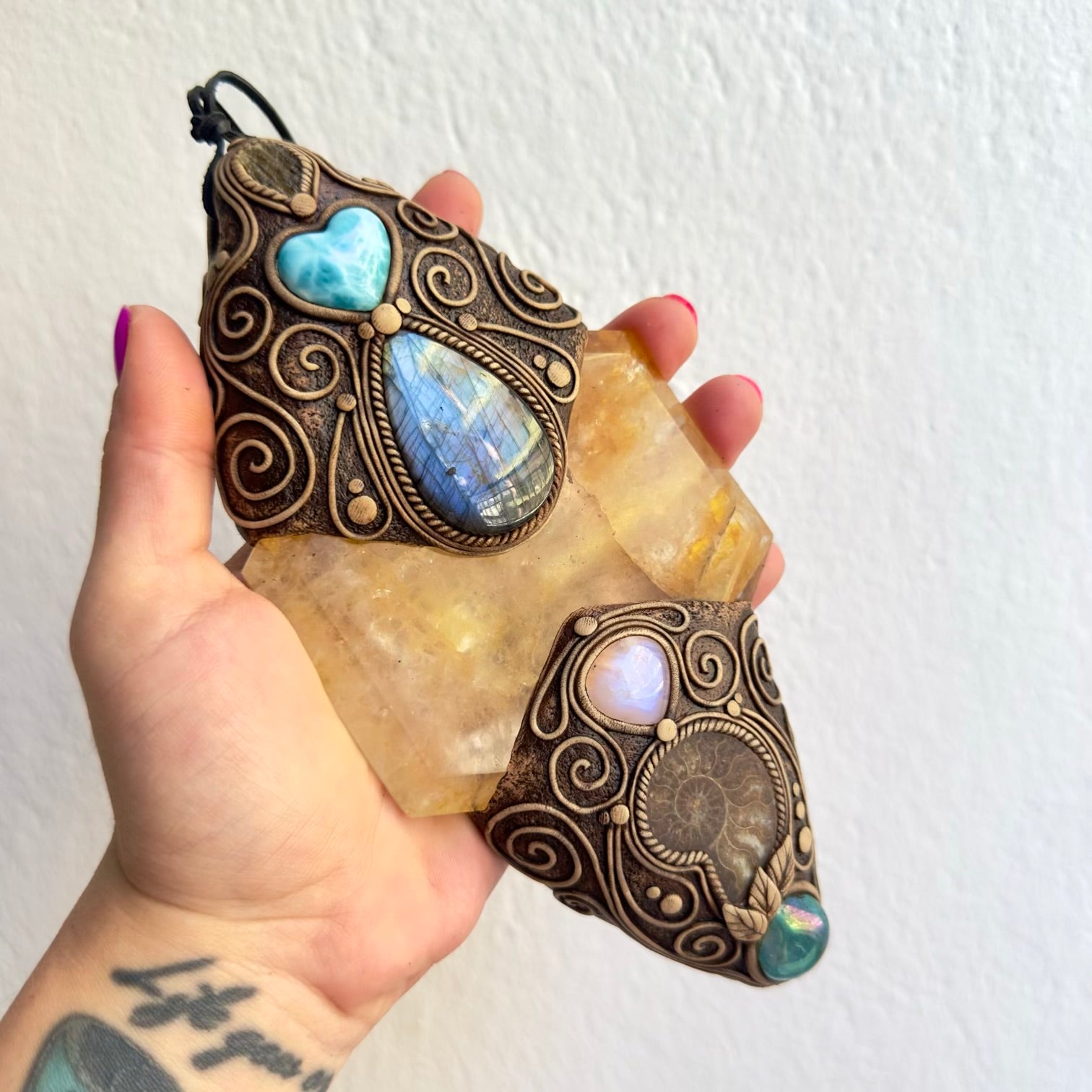 Handmade wall art with healing crystals and ammonite fossil