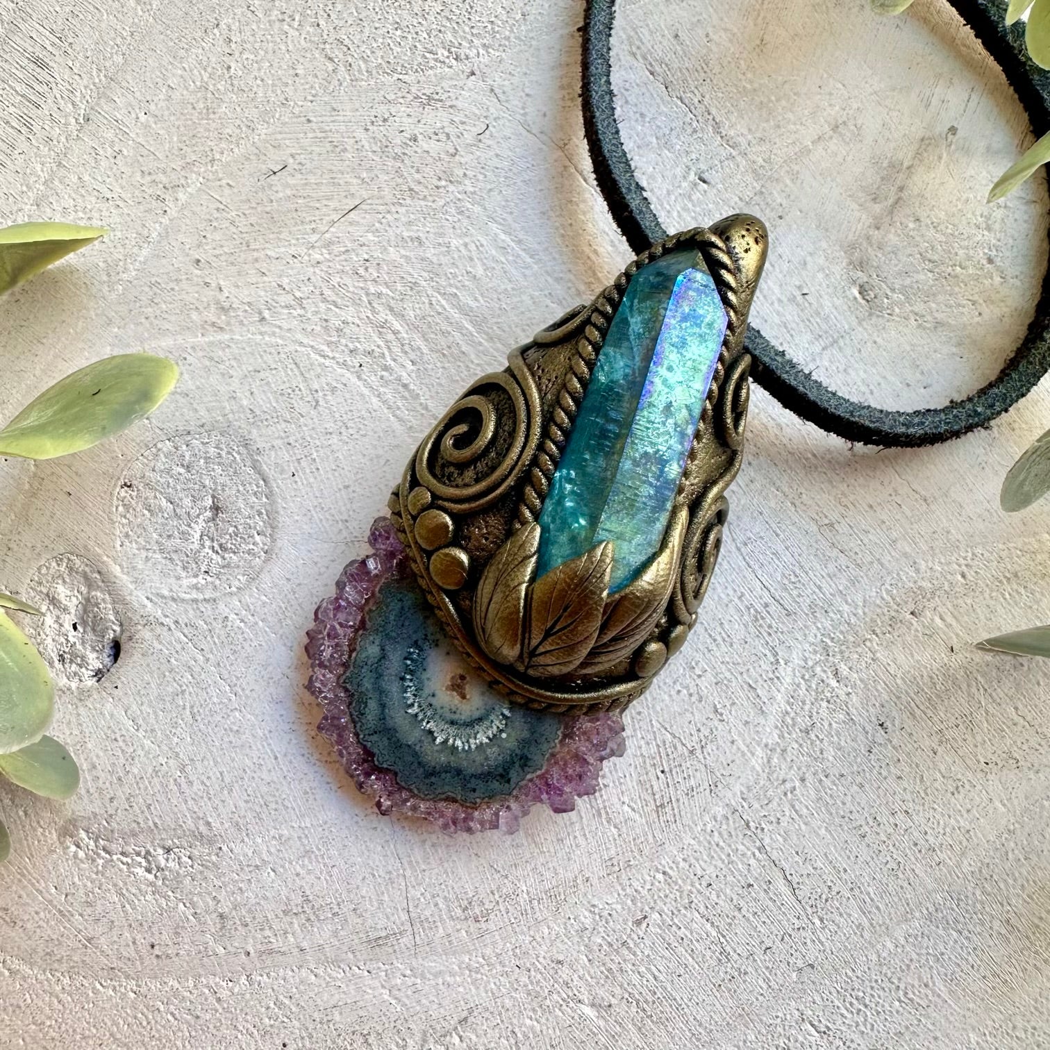 Unique crystal jewelry showcasing the contrast between purple Amethyst and iridescent Aqua Aura Quartz.
