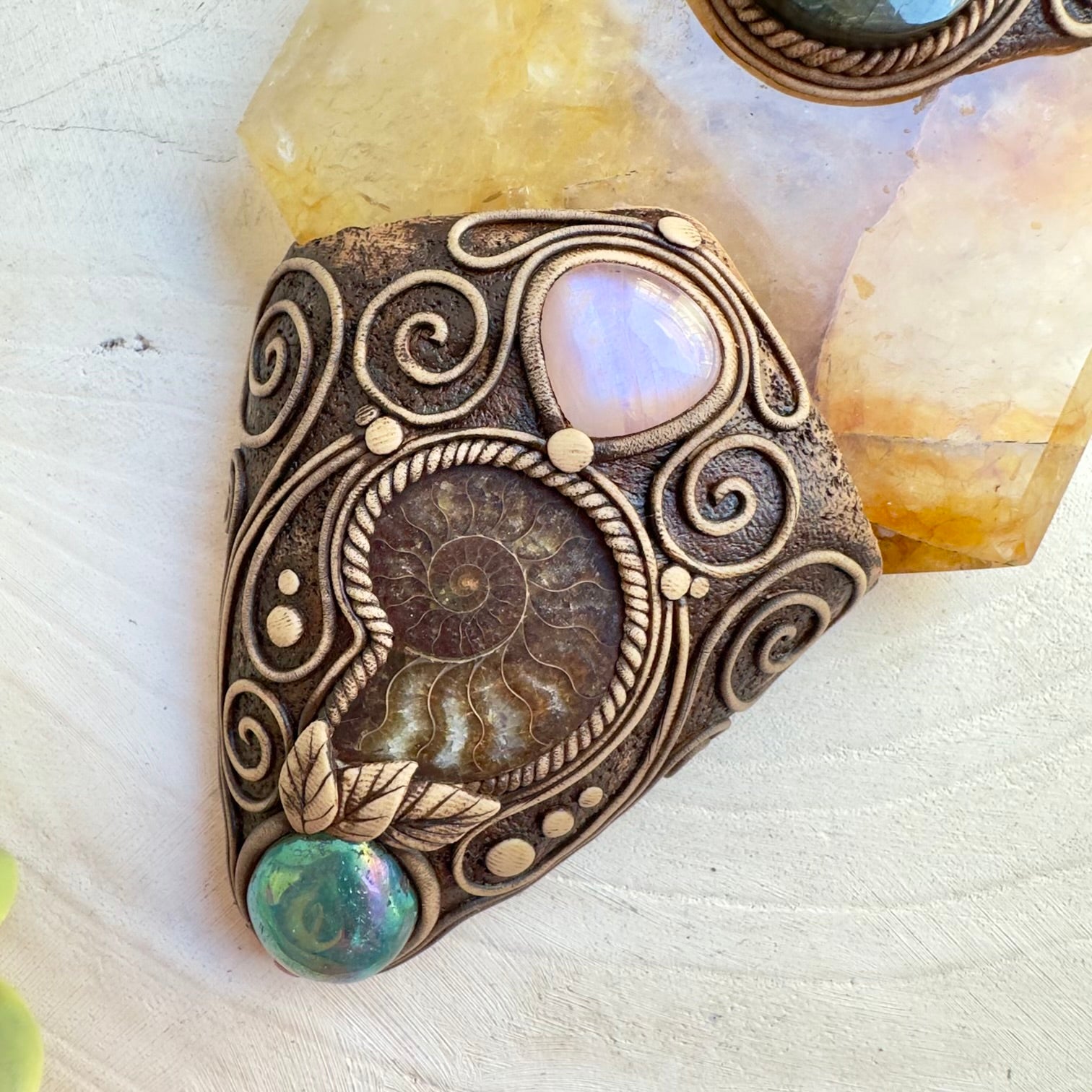 Decorative wall hanging with Golden Healer Quartz and Ammonite