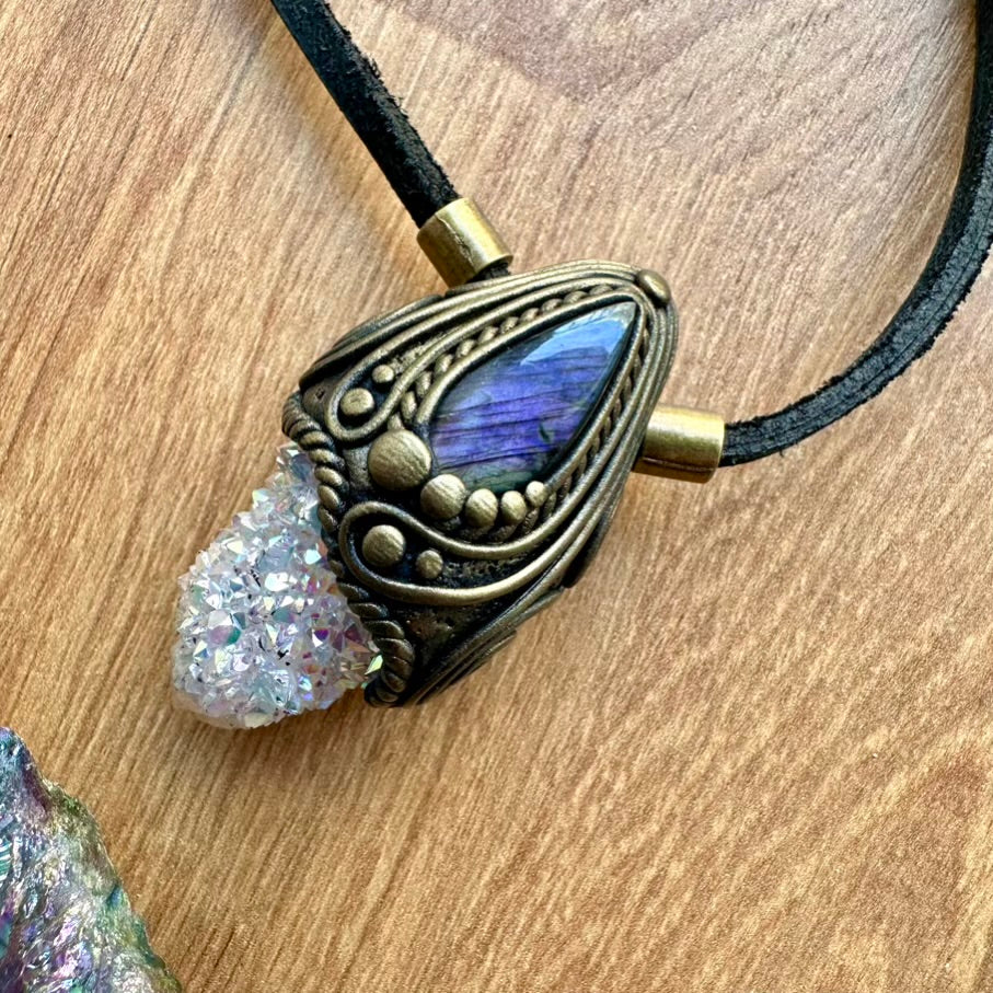 Necklace with gemstone and crystal pendant on a wooden surface