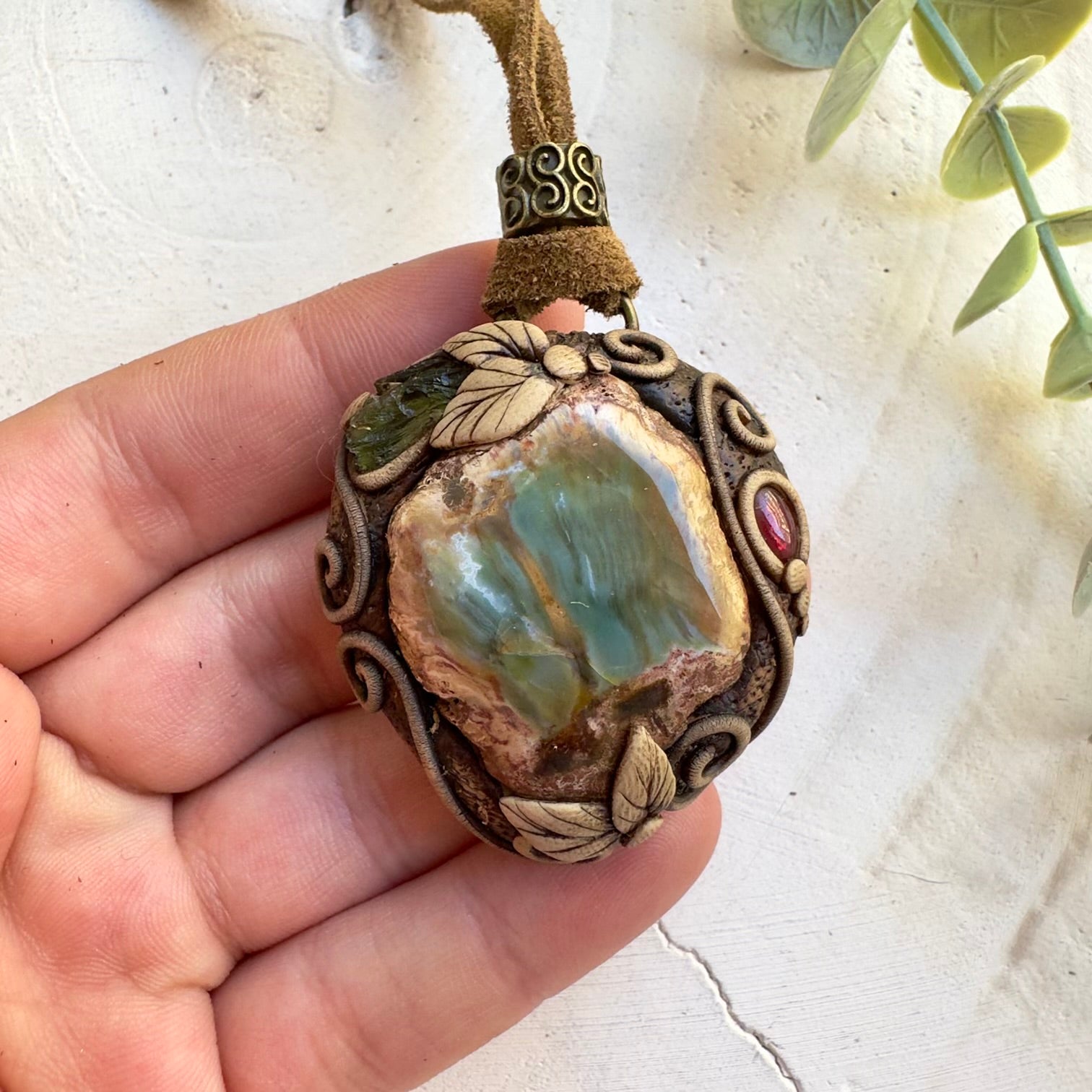 Moldavite and petrified wood pendant necklace with garnet accents