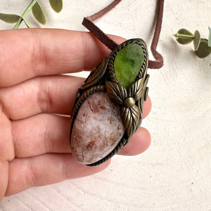 Protection amulet necklace featuring healing crystals Hematite Quartz and Peridot gemstones.