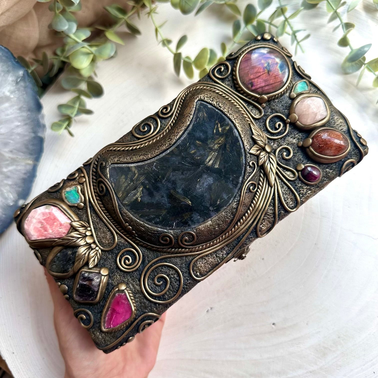 Mystical gemstone storage box featuring astrophyllite moon and Ethiopian opal crystals