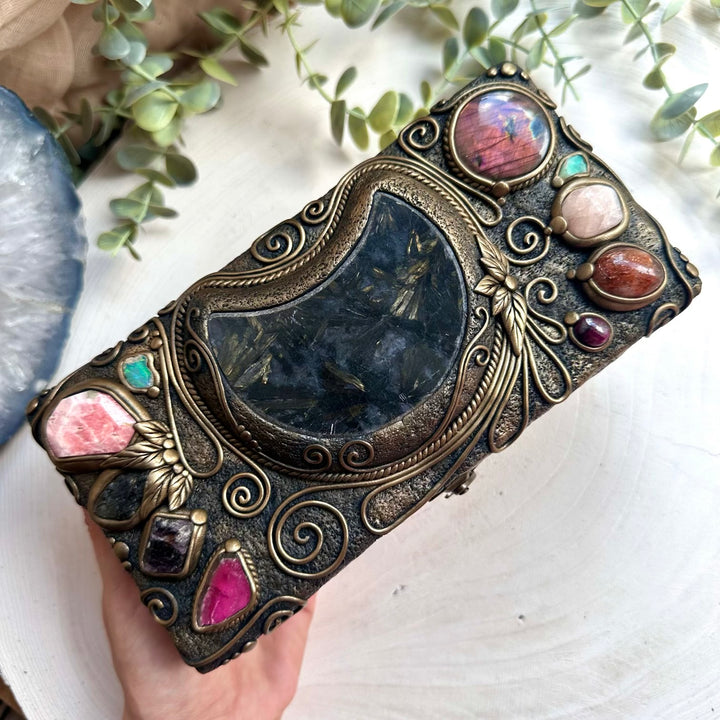 Mystical gemstone storage box featuring astrophyllite moon and Ethiopian opal crystals