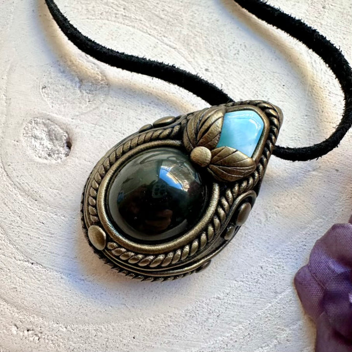 Spiritual calming necklace featuring natural Rainbow Obsidian flash and soothing Larimar energy, handmade with intention.
