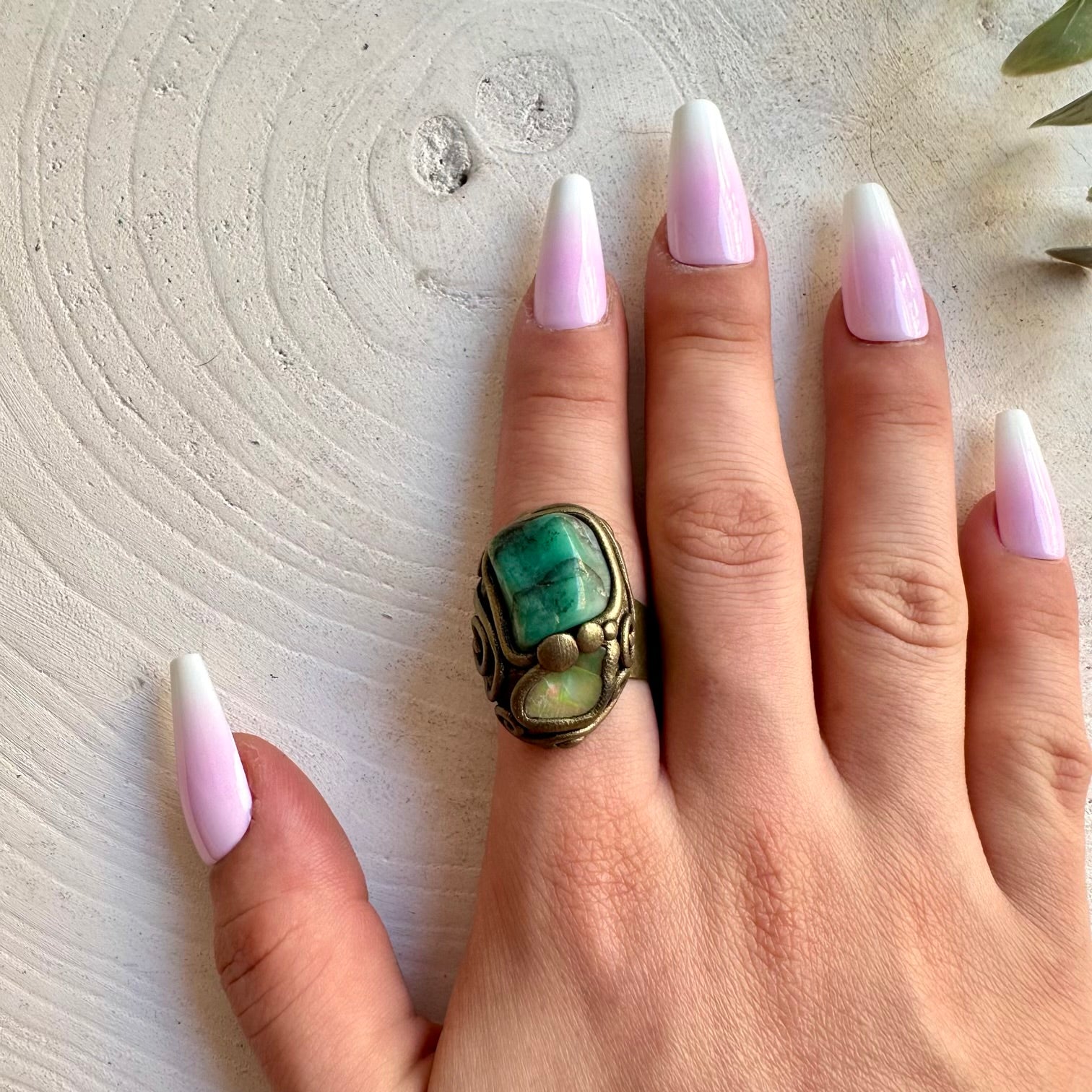 Natural gemstone ring showcasing deep green Emerald with a colorful raw Opal detail.
