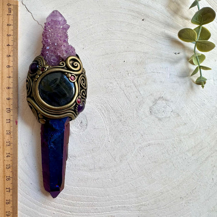 Handmade raw crystal wand featuring Cobalt Aura Quartz, Deep Purple Spirit Quartz, Labradorite, Amethyst and Rhodolite Garnet, a one of a kind energy healing and ritual tool designed for spiritual awakening, intuition, communication, protection and personal transformation. Artisan crystal wand crafted with genuine natural gemstones.